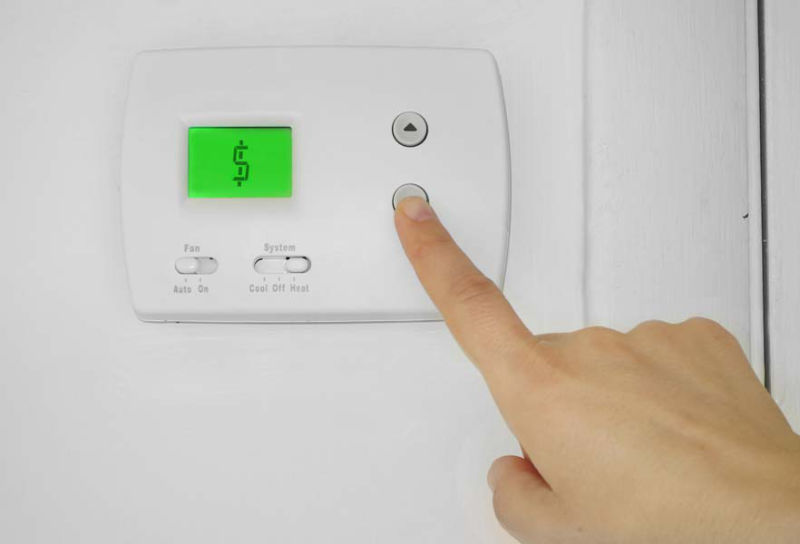 Hand on Thermostat