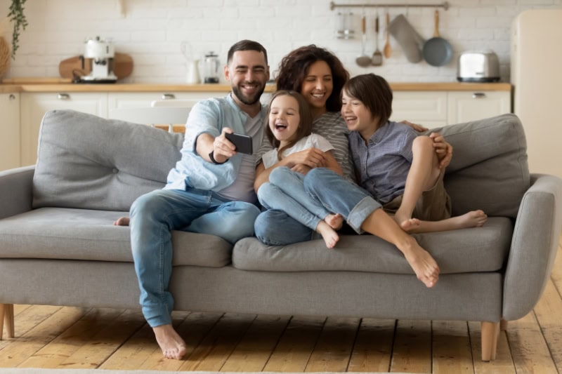 A young family on couch.