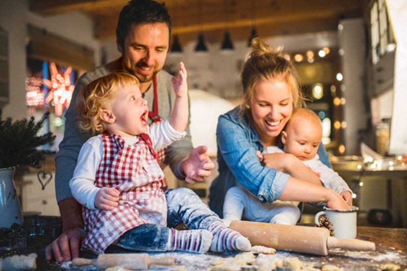 Family with two young kids in the kitchen, 6 Ways Your Furnace Keeps You Safe | HVAC Maintenace, Heating | Acton