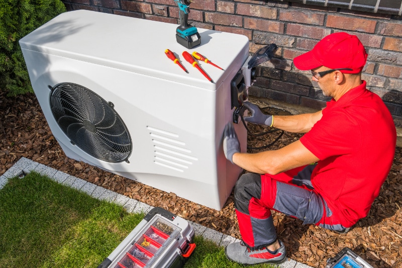 Professional HVAC Technician Modern Heat Pump Unit.