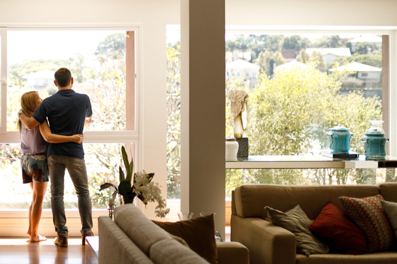 Couple admiring the view from the living room of their house.