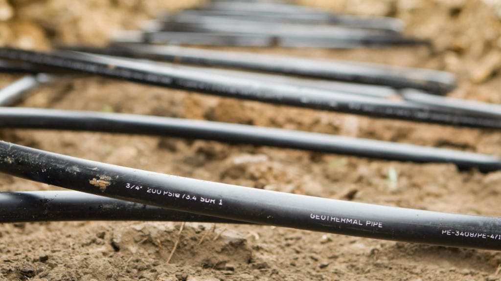 Workers Laying Geothermal Coils in an Underground Trench