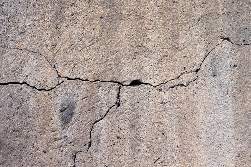 Close up of a concrete slab leak crack in the foundation